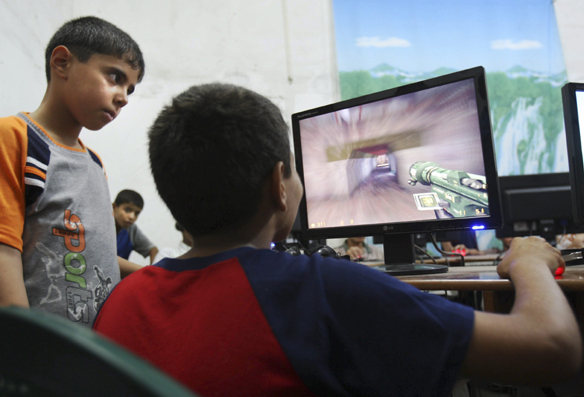 Kids playing computer games (photo by Adel Hana)